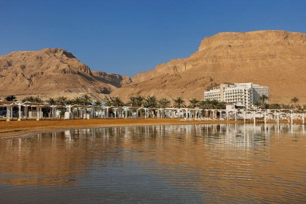 A hotel with a large building and a pool area in front. - Herbert Samuel Hod Dead Sea Hotel (Tamar)