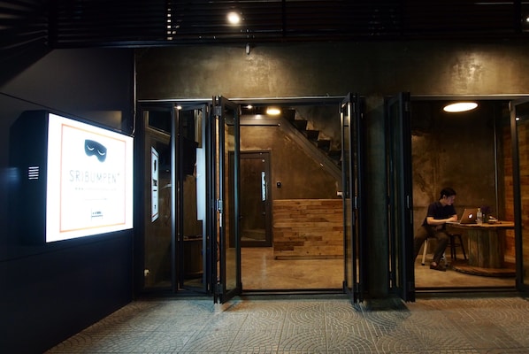 A modern interior with a staircase leading to a wooden floor area.