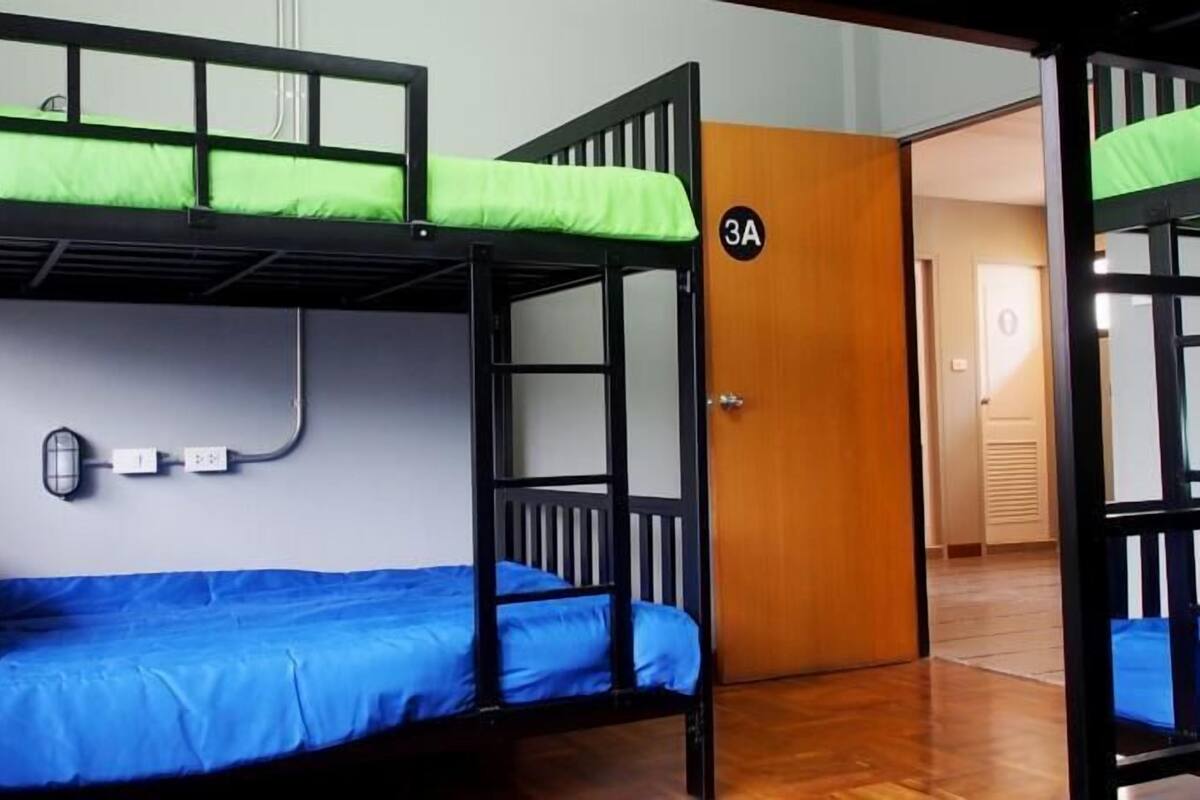A bunk bed room with a number 1 sign, a power outlet, and a door labeled 3A.