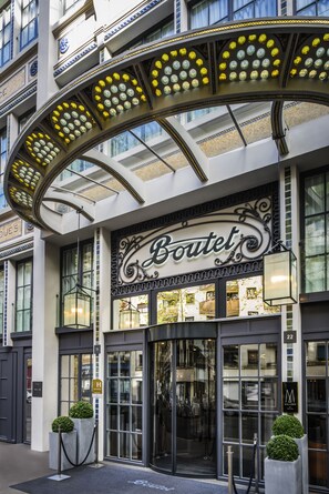 A hotel entrance with a large illuminated sign reading "Boutel's". - Boutet Bastille Hotel Paris - MGallery Collection (Paris)
