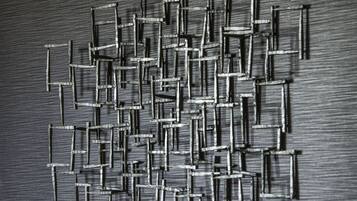 A close-up of a textured surface with a pattern of interlocking metal bars.
