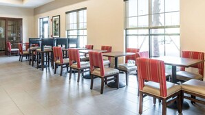 A spacious dining area with multiple tables and chairs, large windows providing natural light, and a modern interior design. - Comfort Suites Dunnellon near Rainbow Springs (Dunnellon)