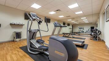 A gym with treadmills, elliptical machines, and a stationary bike.