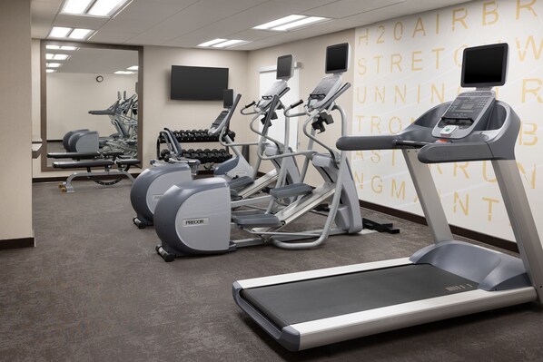A gym with treadmills, ellipticals, and dumbbells. - Residence Inn by Marriott Kansas City at The Legends (Kansas City)