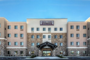 A Staybridge Suites hotel with a modern facade, multiple windows, and a prominent entrance. - Staybridge Suites St Louis - Westport by IHG (Maryland Heights)