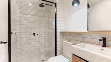 Shower, designer toiletries, hair dryer, towels