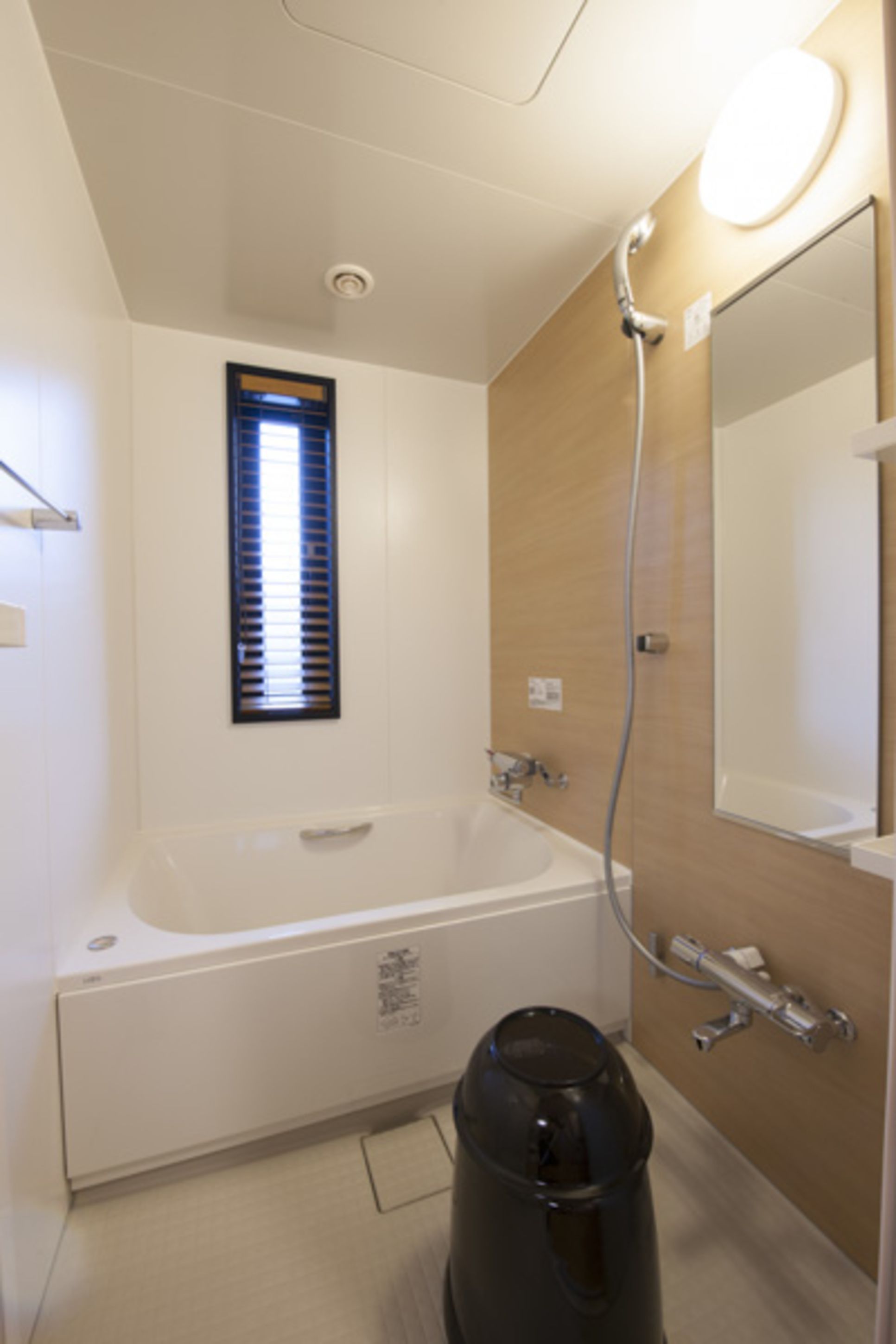 A modern bathroom with a bathtub, a shower, a sink, and a mirror.