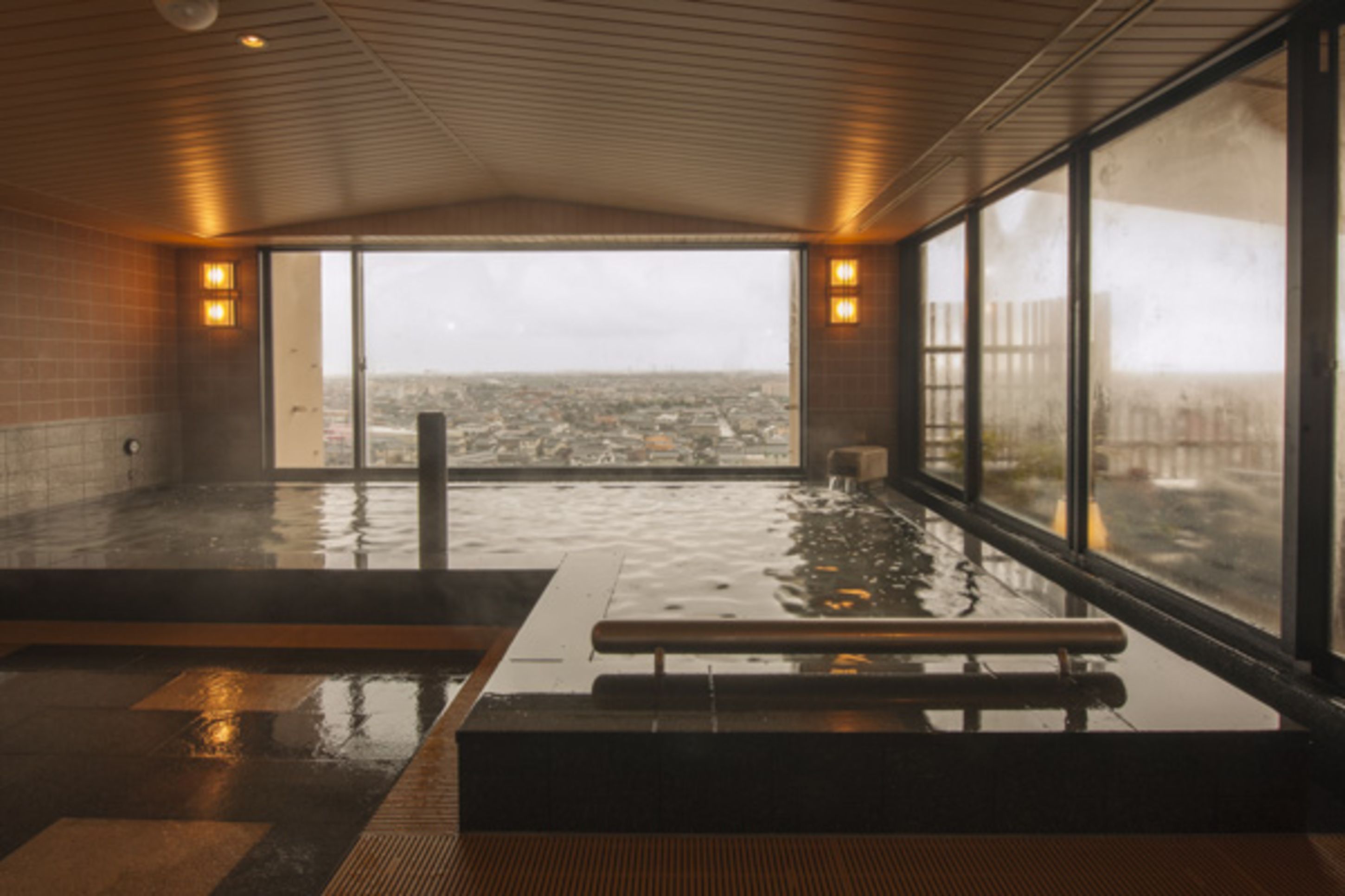 A spa with a large window offering a city view.