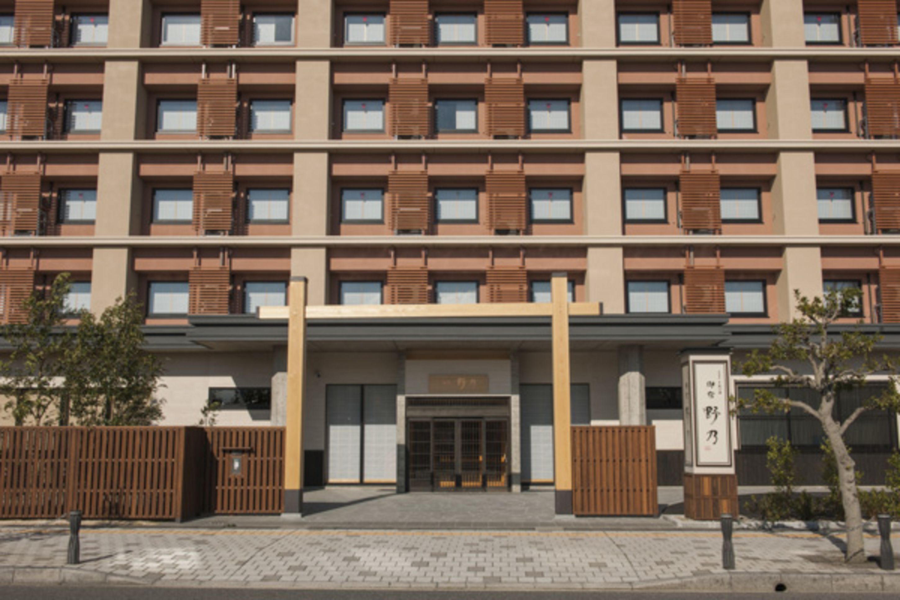 A multi-story building with a modern facade, featuring a series of windows and a central entrance.