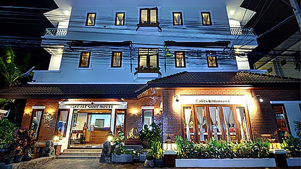 A two-story building with a restaurant on the ground floor and a guesthouse on the upper floor.