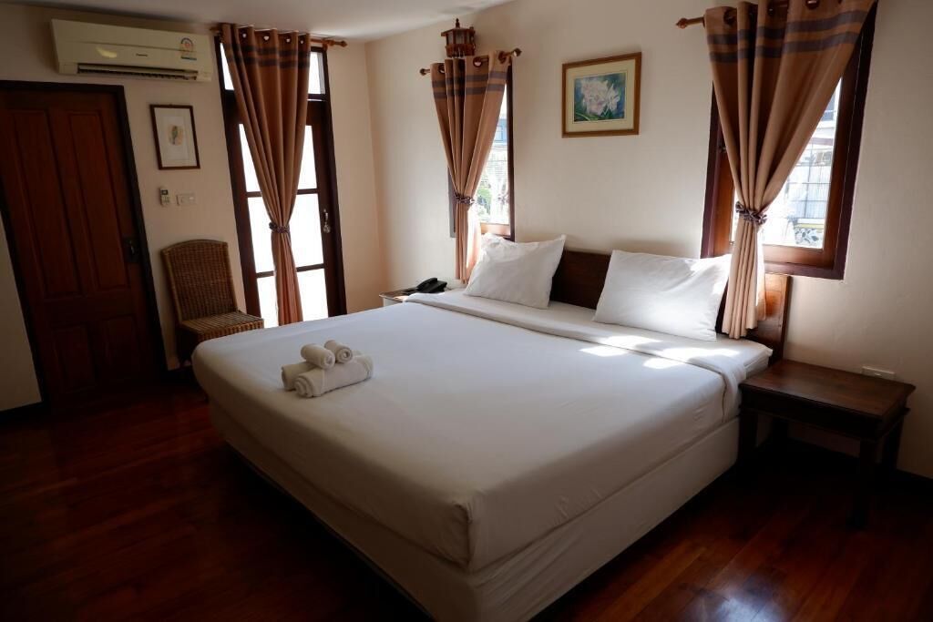 standard king bed room with window and balcony at the corner | in-room safe, blackout curtains, rollaway beds, free wifi