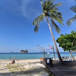 On the beach, white sand, beach umbrellas, beach towels