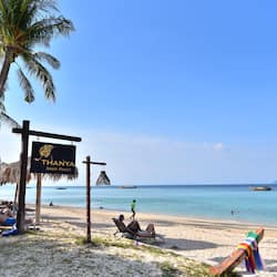 On the beach, white sand, beach umbrellas, beach towels
