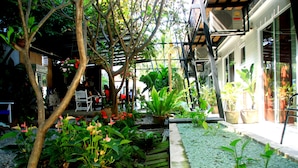A garden area with various plants and a small pond. - Ganesha House (Chiang Mai)