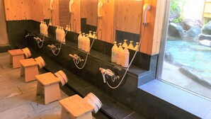 A public restroom with multiple sinks, hand soap dispensers, and wooden stools. - Onsen Hostel K's House Hakone (Hakone)