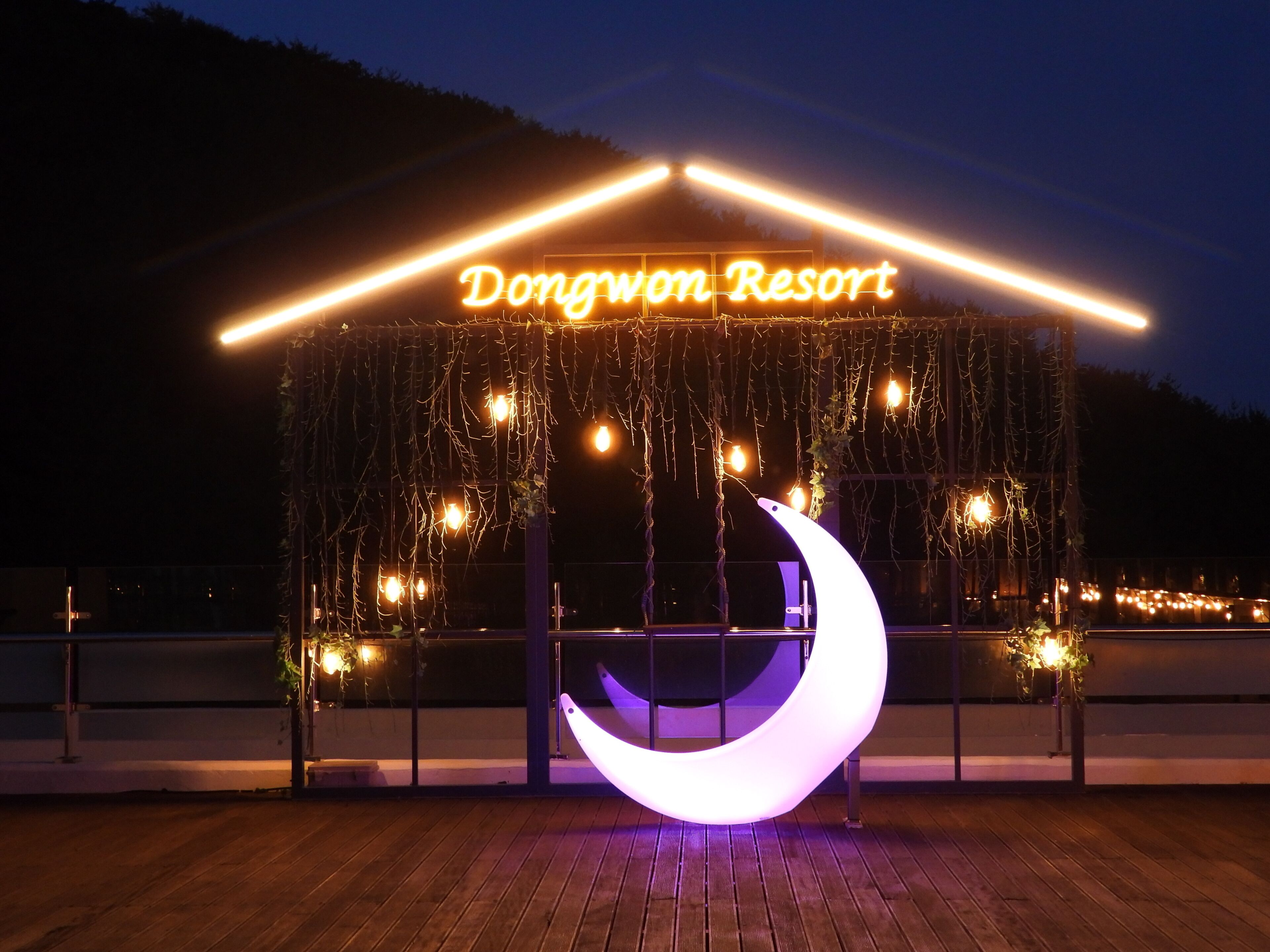 A resort sign with a crescent moon decoration.