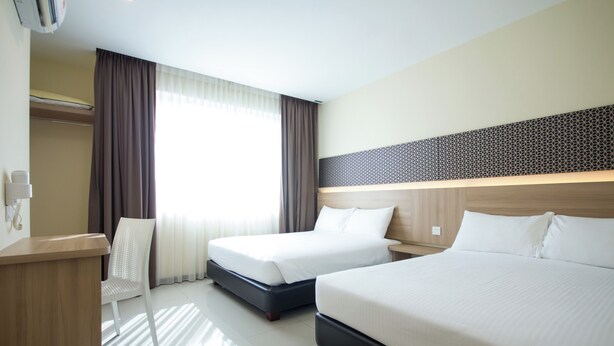 A hotel room with two beds, a desk, a chair, and a large window with curtains. - 118 Hotel Macalister (George Town)