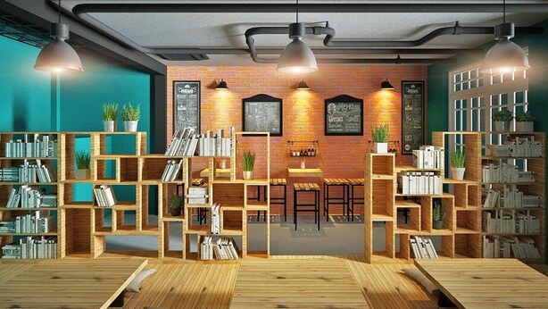 A cozy library with wooden bookshelves, tables, and hanging lights. - Like Backpacker Hostel (Da Nang)