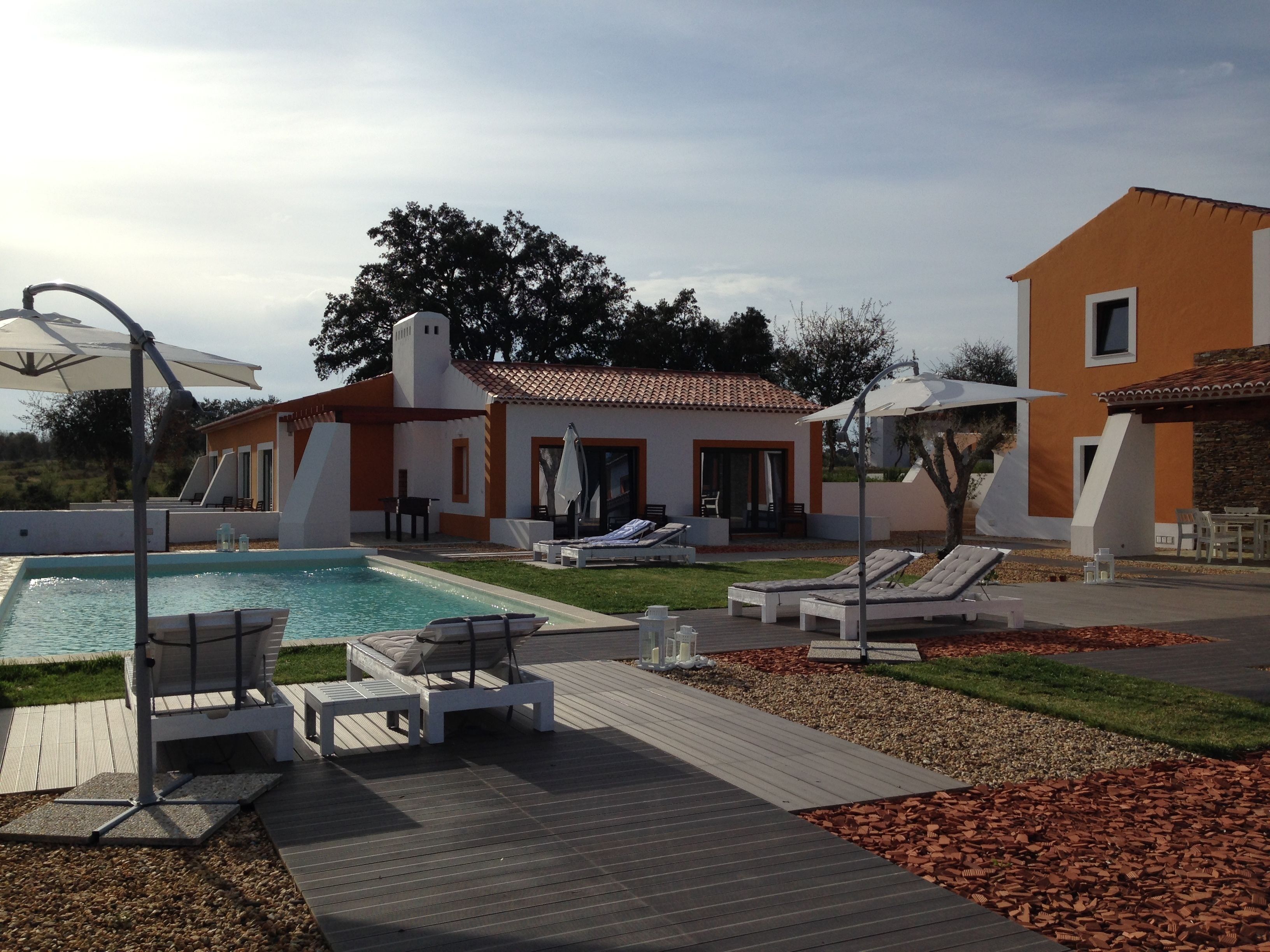 A modern poolside area with lounge chairs and a small pool.