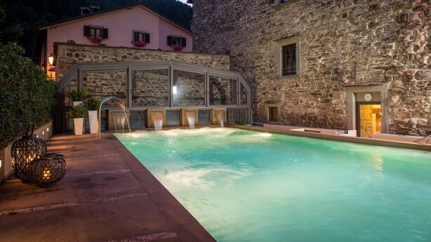 A stone building with a pool and a glass structure. - Hotel Delle Terme Santa Agnese (Bagno di Romagna)