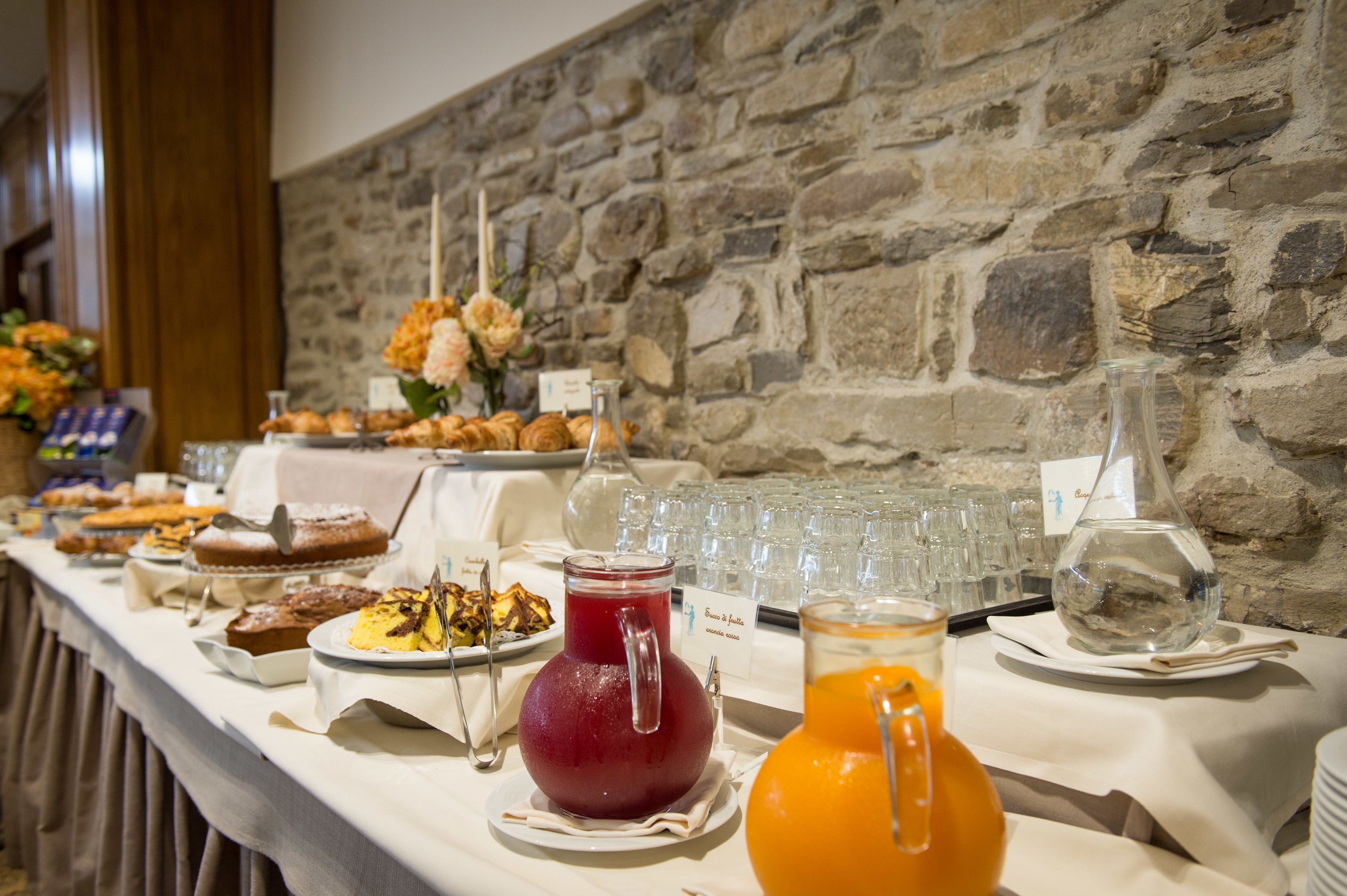 A buffet table with various food items and beverages.