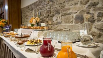 A buffet table with various food items and beverages.