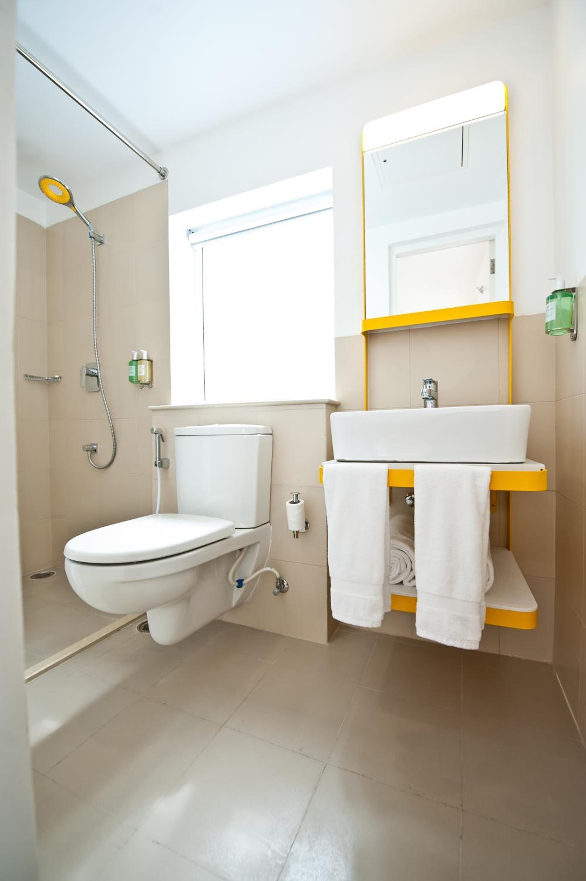 A modern bathroom with a toilet, sink, and shower.