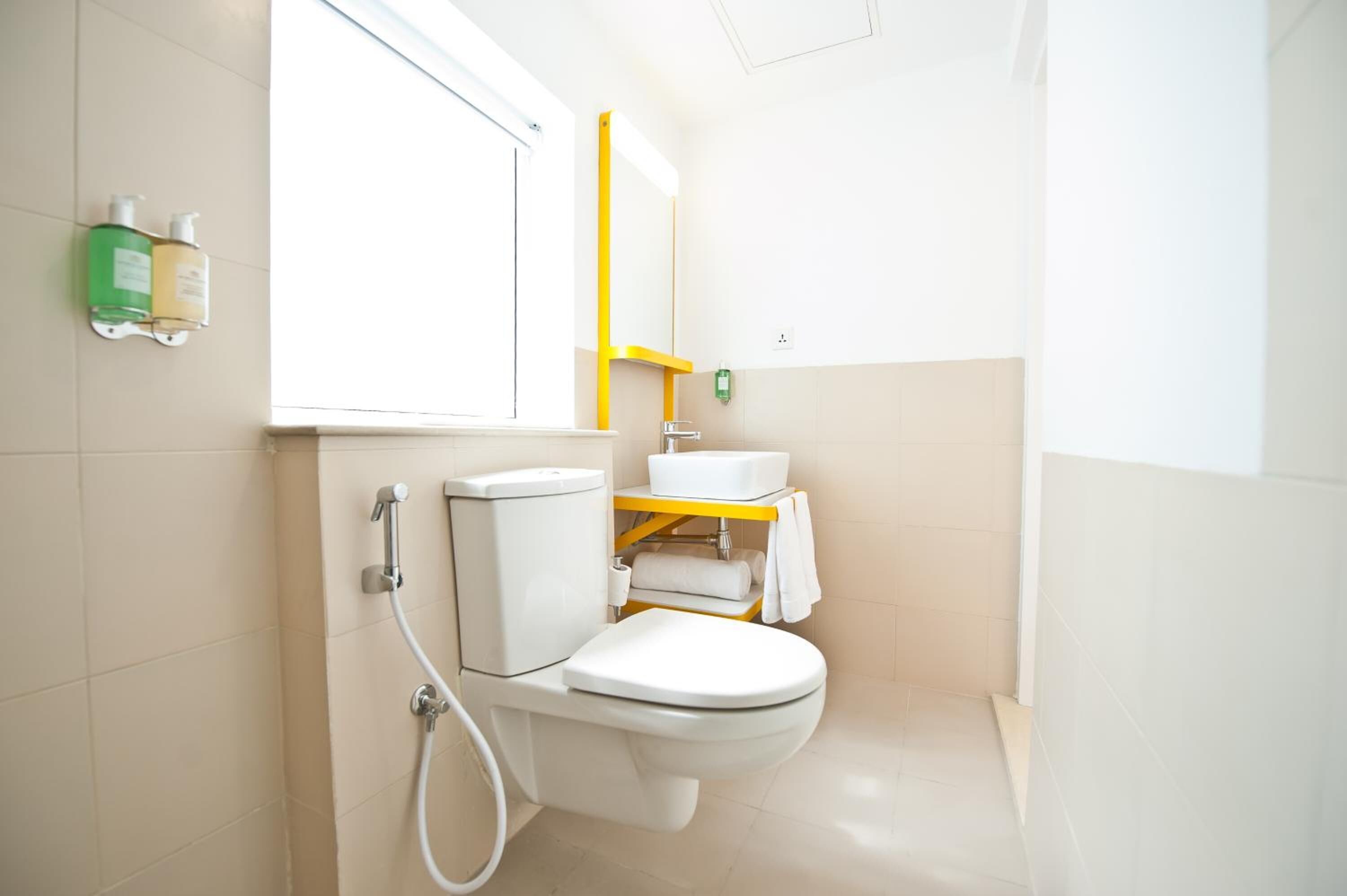 A modern bathroom with a toilet, sink, and shower.