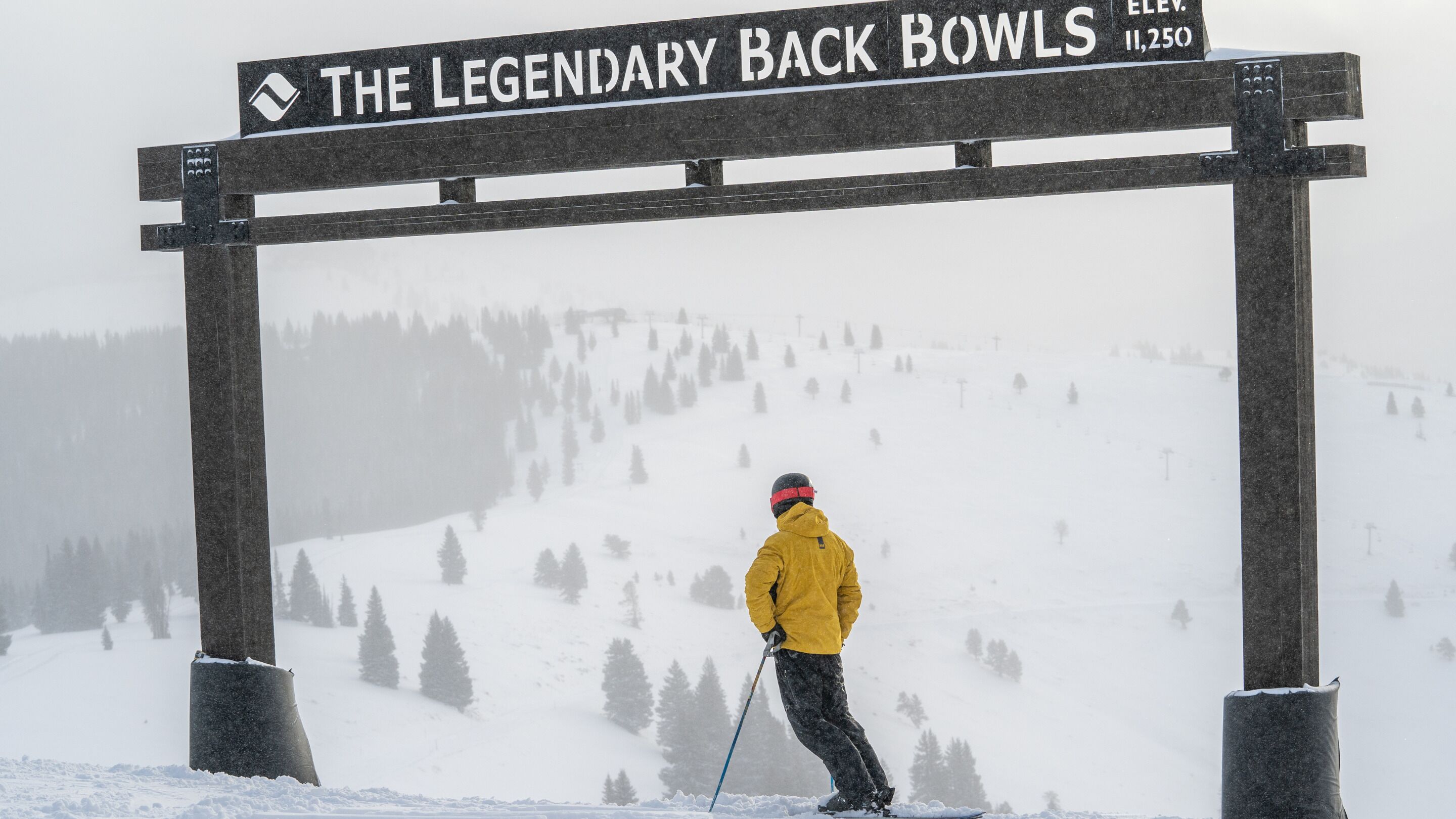A wooden sign with the text "THE LEGENDARY BACK BOWLS" and elevation "11,250".
