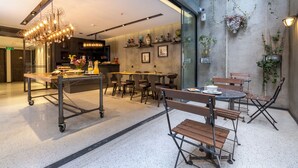 A modern dining area with a central bar, seating arrangements, and decorative elements like plants and wall art. - Lampa Design Hotel - Special Class (Istanbul)