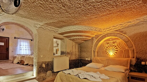 Ein gemütliches Schlafzimmer mit einem Bett, einem Nachttisch und einem außergewöhnlichen Deckenstil.