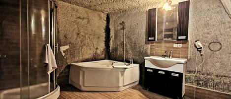 A bathroom with a shower, bathtub, and toilet.