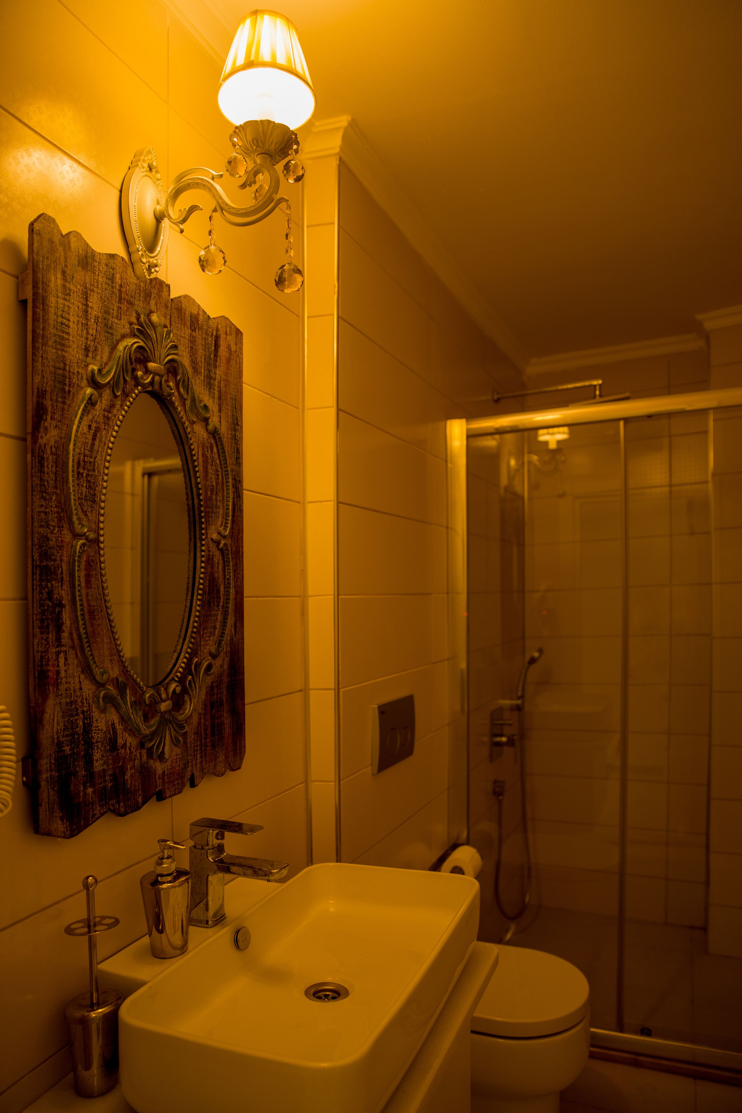 A bathroom with a sink, toilet, and shower.