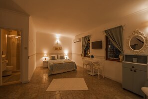 A bedroom with a bed, bedside tables, a desk, a chair, a dresser, and a mirror. - 8 Oda Boutique Homes (Marmaris)
