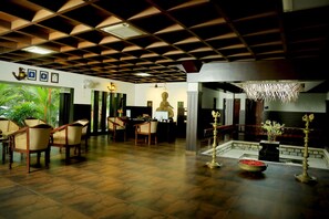 A spacious lobby with a high ceiling, a Buddha statue, and a chandelier. - Malabar Ocean Front Resort & Spa (Hosdurg)
