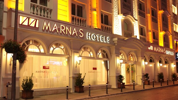 The exterior of Marinas Hotels with arched windows and a well-lit facade. - Marnas Hotels (Istanbul)