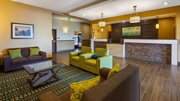 A hotel lobby with a reception desk, seating area, and a fireplace. - Best Western Plus Moosomin Hotel (Moosomin)