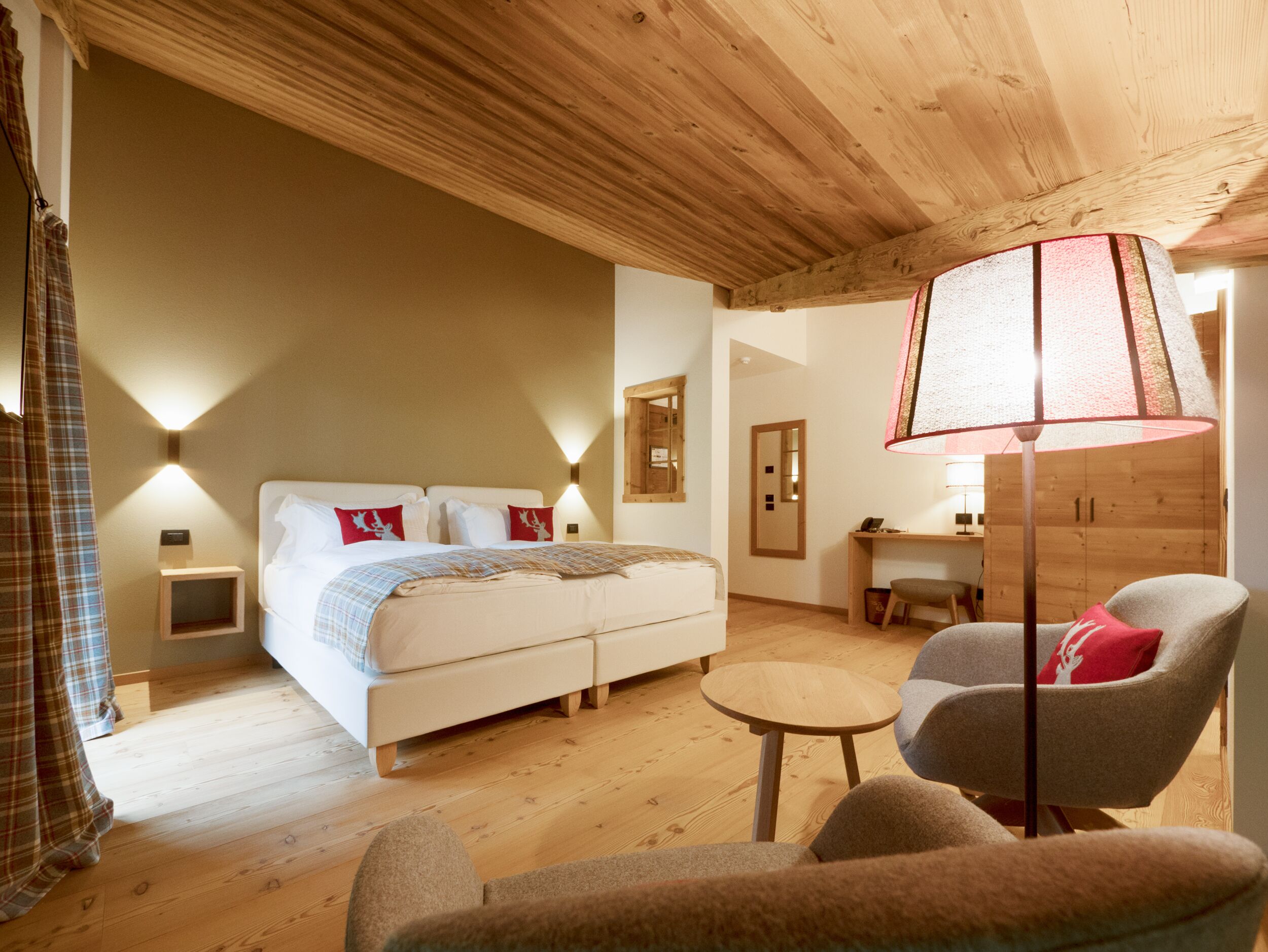 A cozy bedroom with a bed, a desk, and a chair.