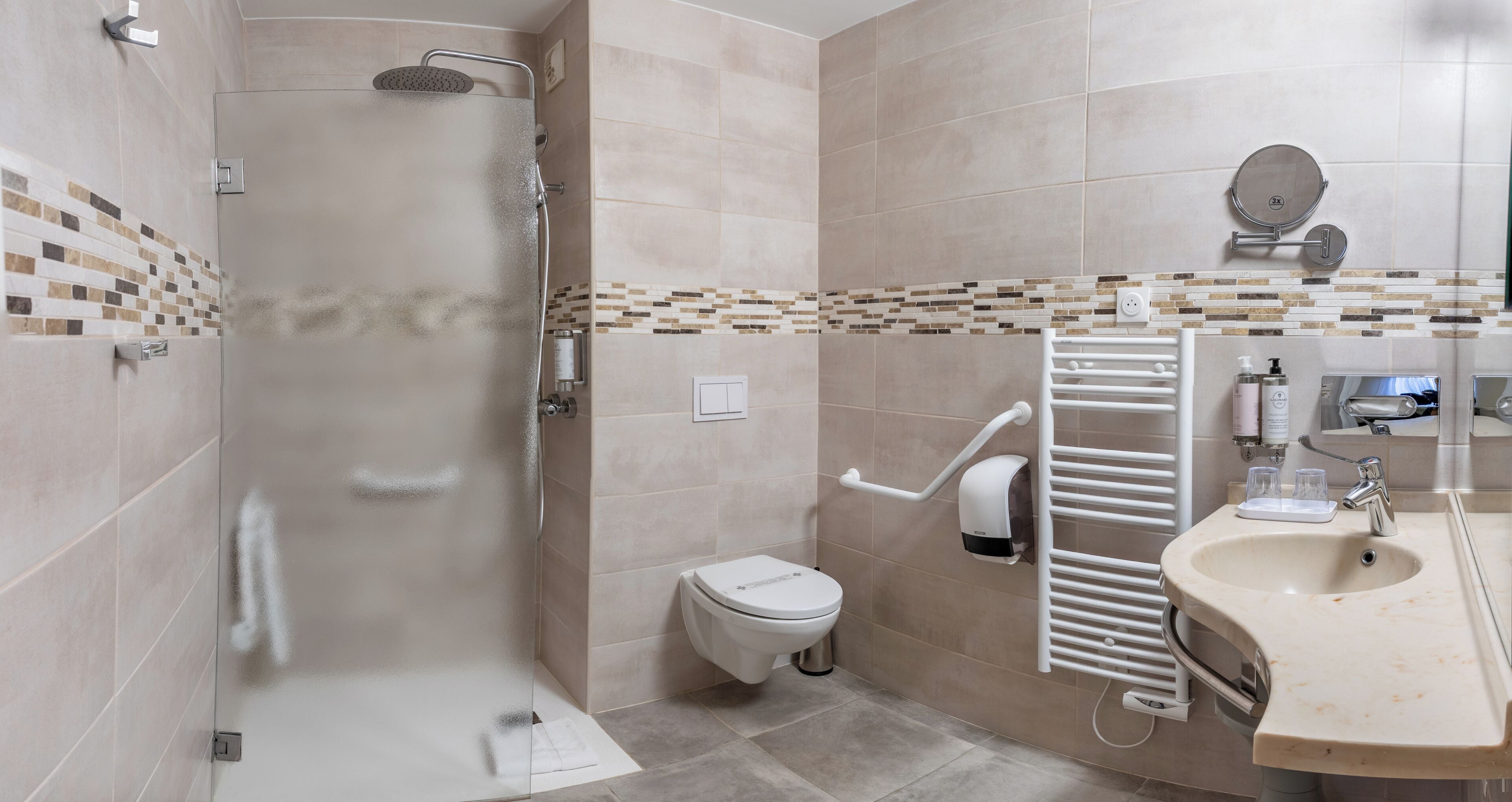 A modern bathroom with a shower, toilet, and sink.