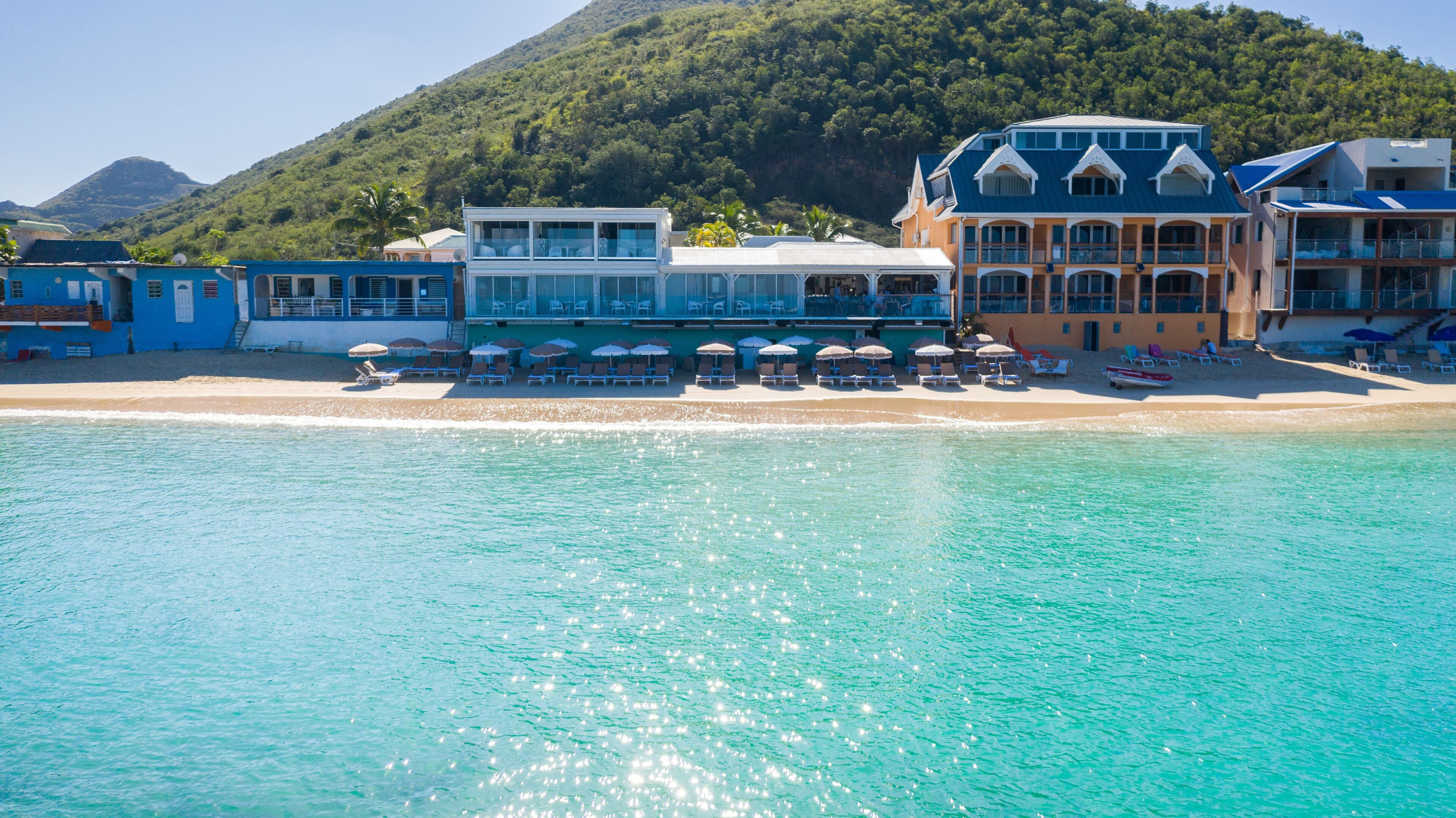 On the beach, white sand, sun-loungers, beach umbrellas