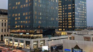 A modern high-rise building with multiple floors and large windows, surrounded by a busy street with moving vehicles. - Assila, a Luxury Collection Hotel, Jeddah (Jeddah)