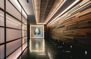 A modern hallway with a wooden wall, a tiled floor, and a framed artwork on the wall. - Noku Kyoto (Kyoto)