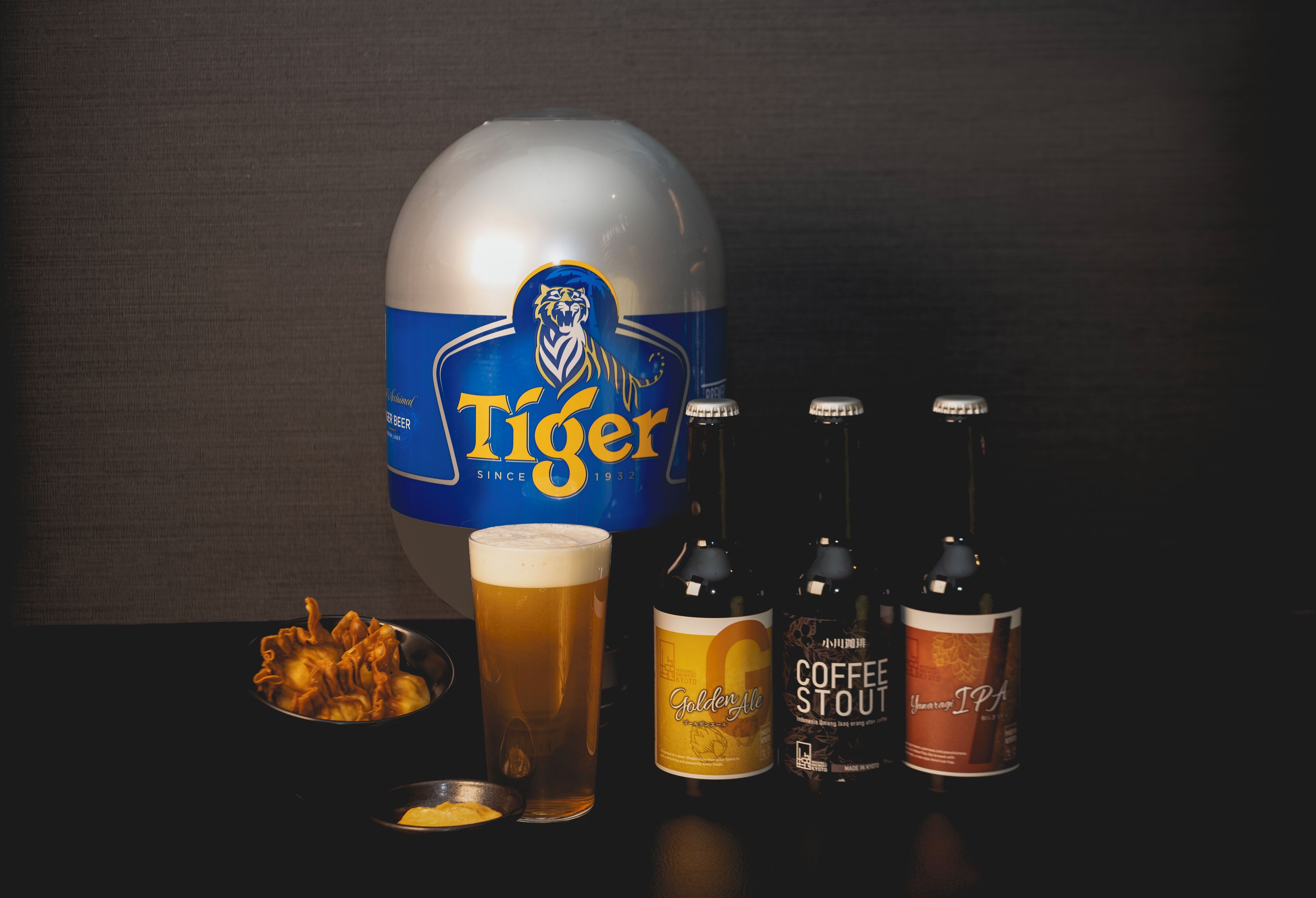 A beer mug, a glass of beer, and two bottles of beer.