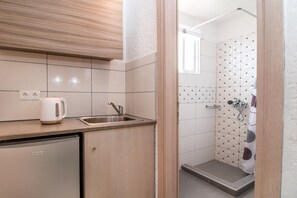 Mini-fridge, stovetop, coffee/tea maker, cookware/dishes/utensils