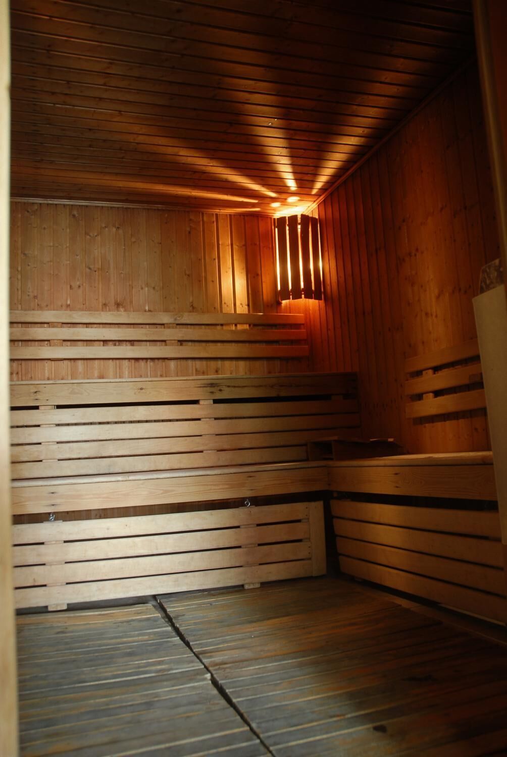 A sauna with wooden walls and benches.