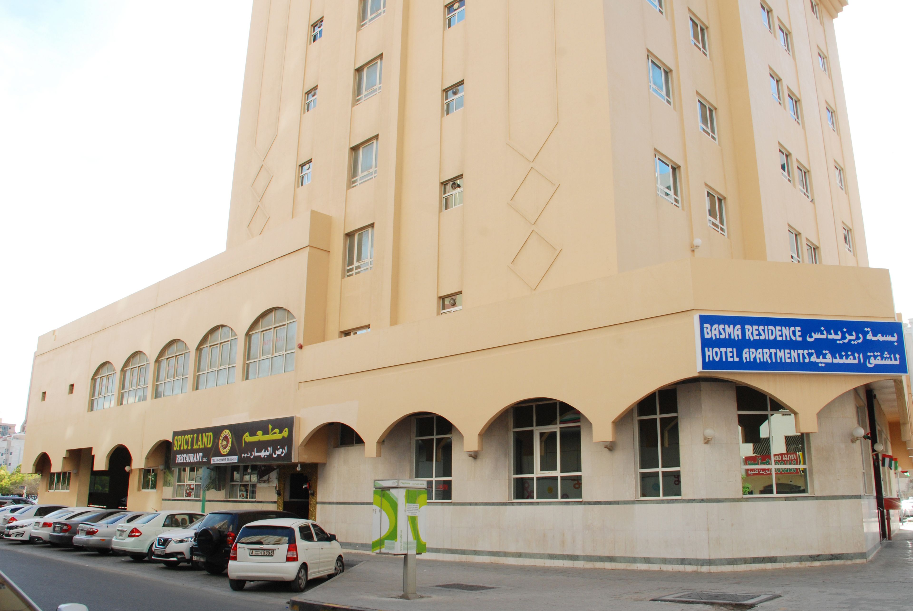 A hotel with multiple floors, a parking lot, and a restaurant named "SpicTland".