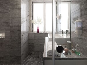 A modern bathroom with a large mirror, a sink, and a window with a view of trees. - LSA Baixa Castelo by Numa (Lisbon)