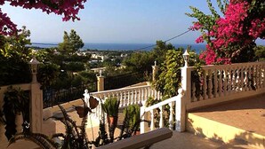 A coastal view with a white balustrade and pink bougainvillea. - Stella View Studios (Rhodes)