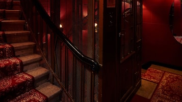A staircase with a metal railing and carpeted steps.