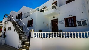 A white building with a staircase, balconies, and a sign for 'BOMMA STUDIOS'. - Domna Studios (Rhodes)